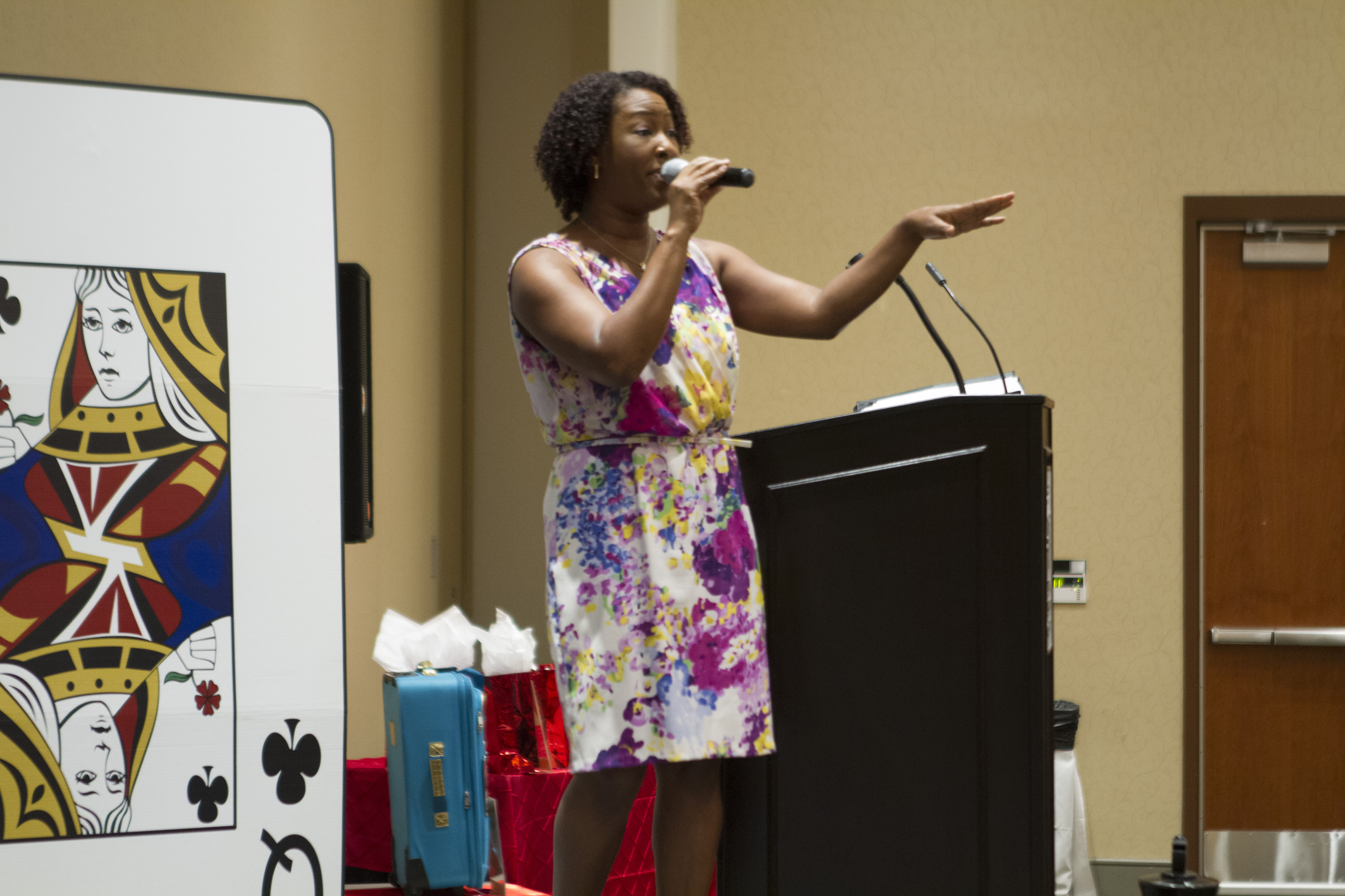 A woman speaks to conference attendees