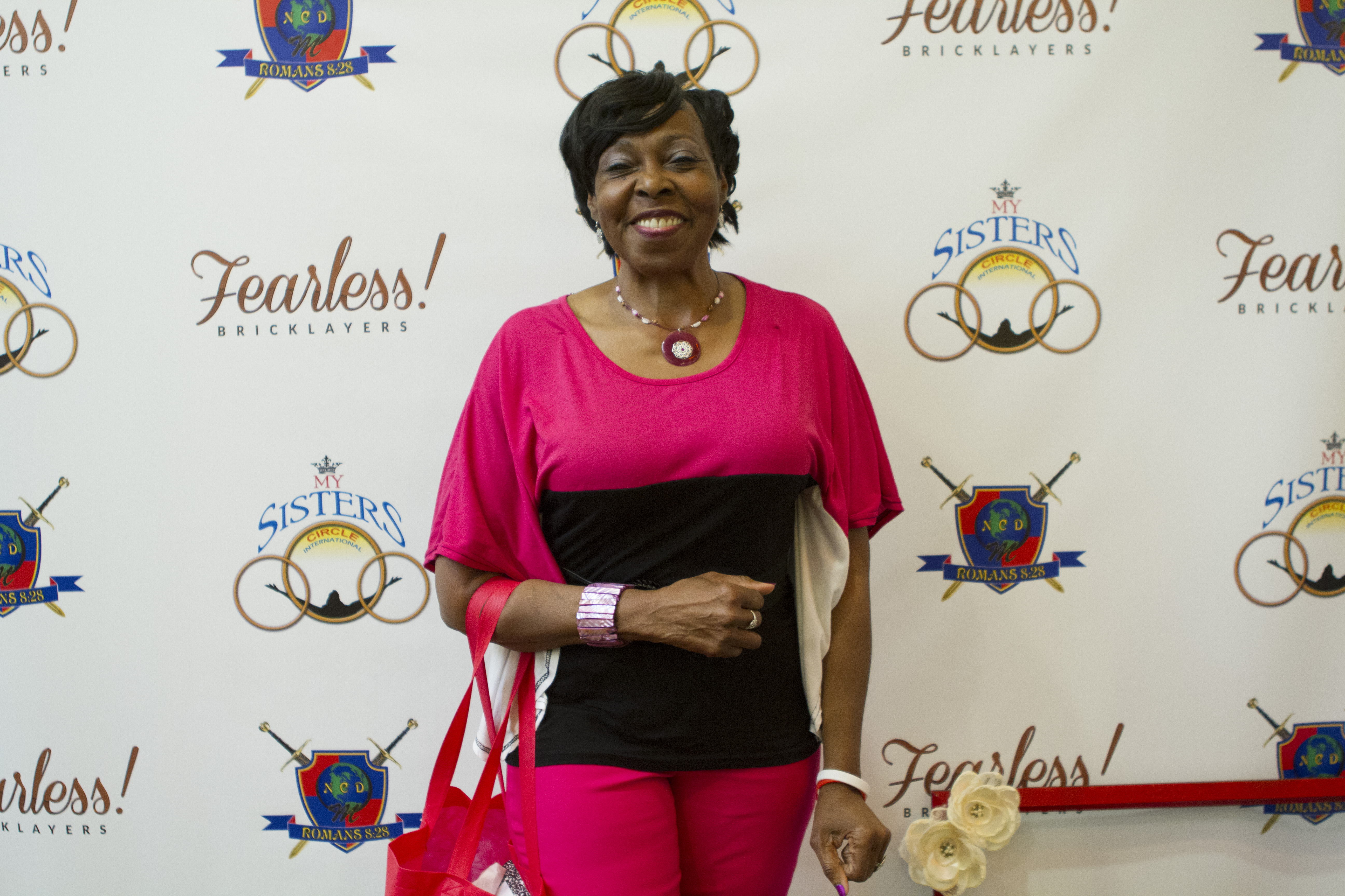 A beautiful woman in pink poses for the camera