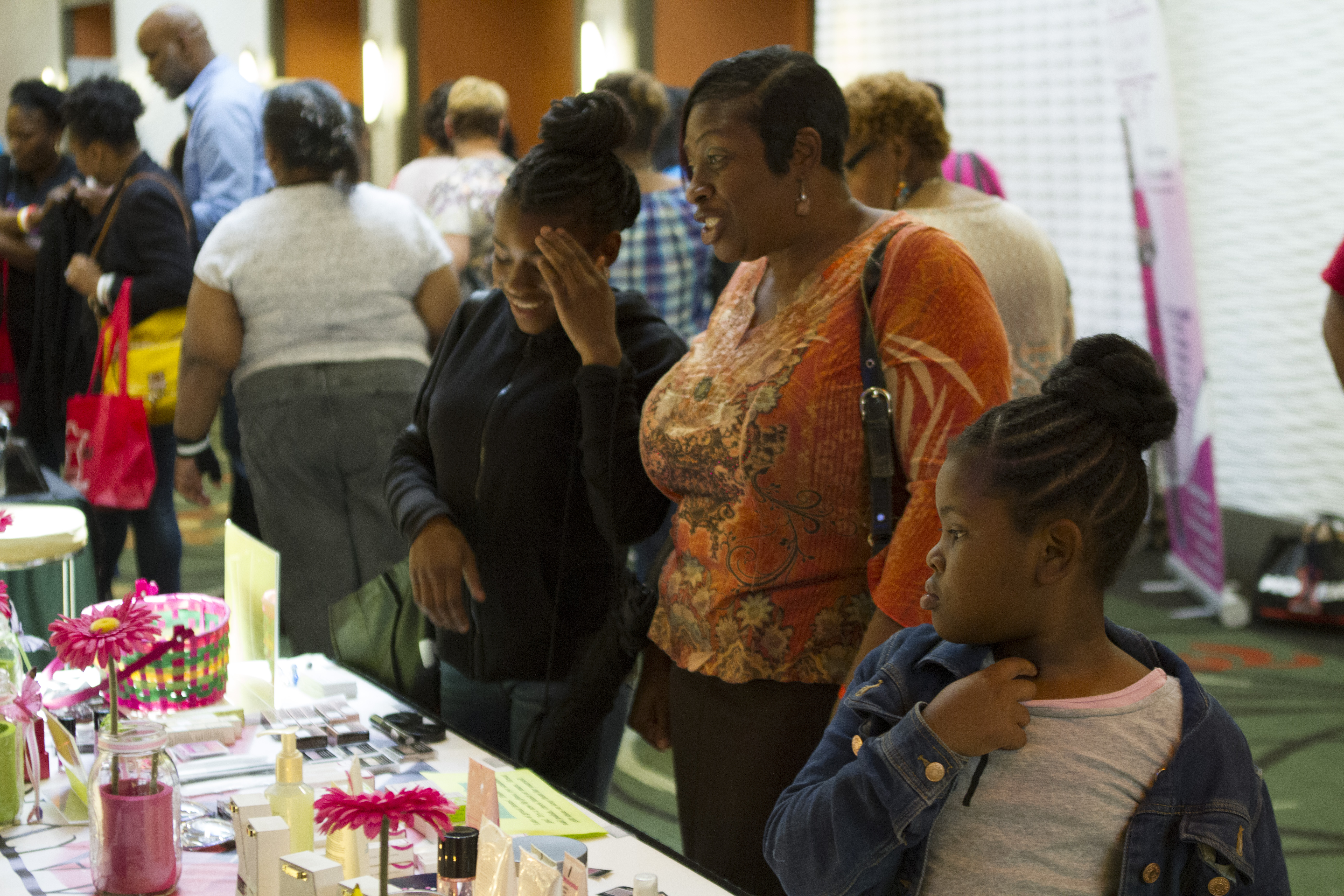 A Woman and her daughters visit a No Fear Conference vendor